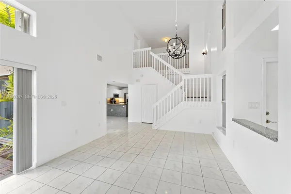 a view of a livingroom with wooden floor and white walls