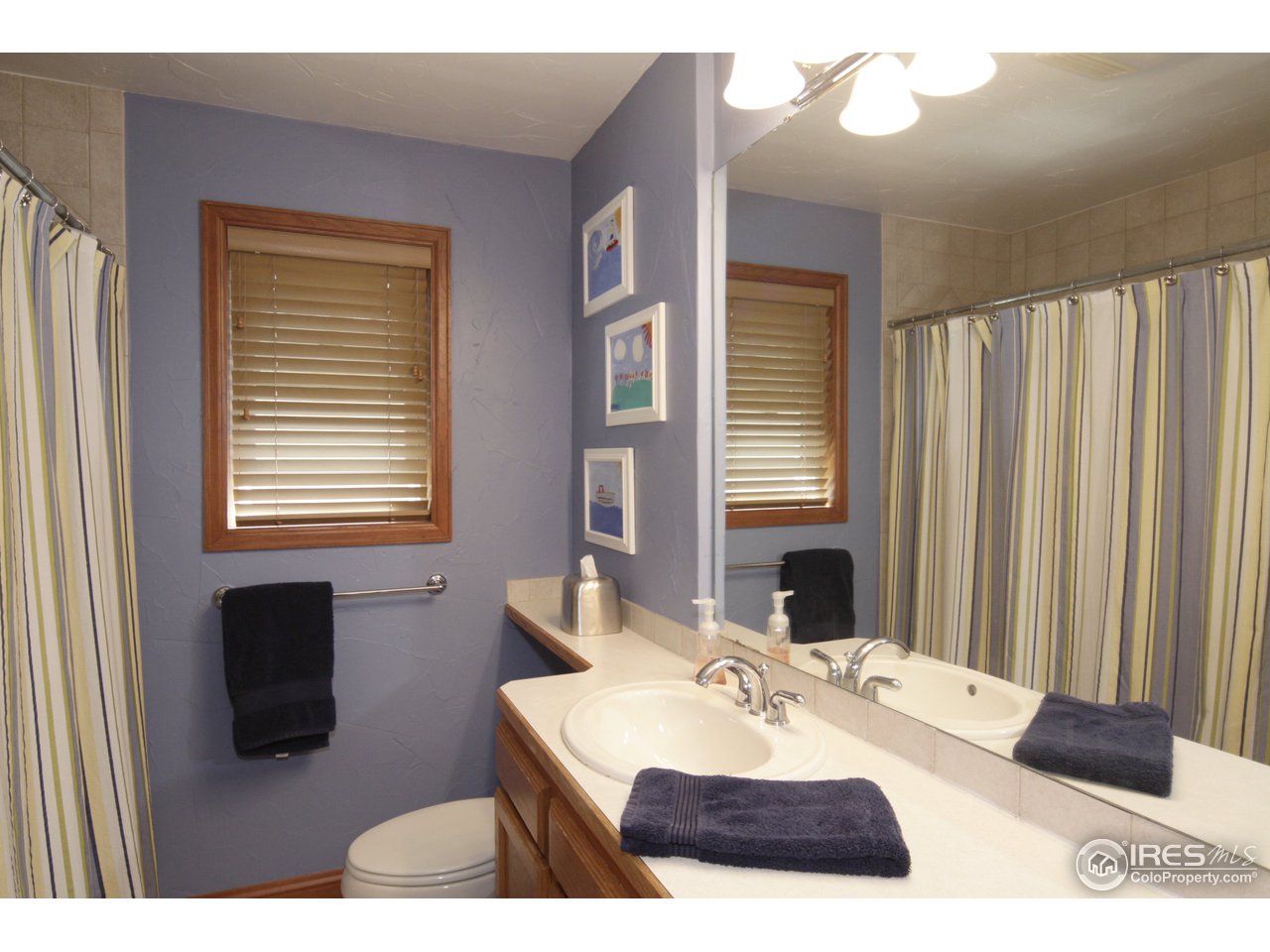 1084 Gapter Road Boulder, CO 80303 - Photo 16 of 25 a bathroom with a sink a mirror and a bathtub