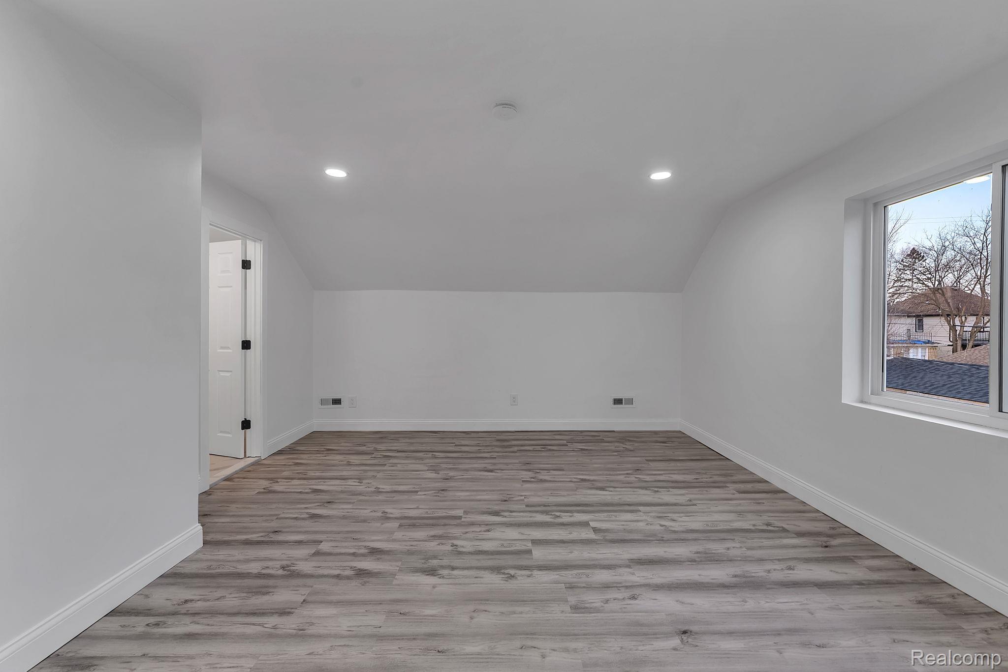 4113 Devonshire Road Detroit, MI 48224 - Photo 21 of 36 Bonus room featuring light wood-type flooring, lofted ceiling, and recessed lighting