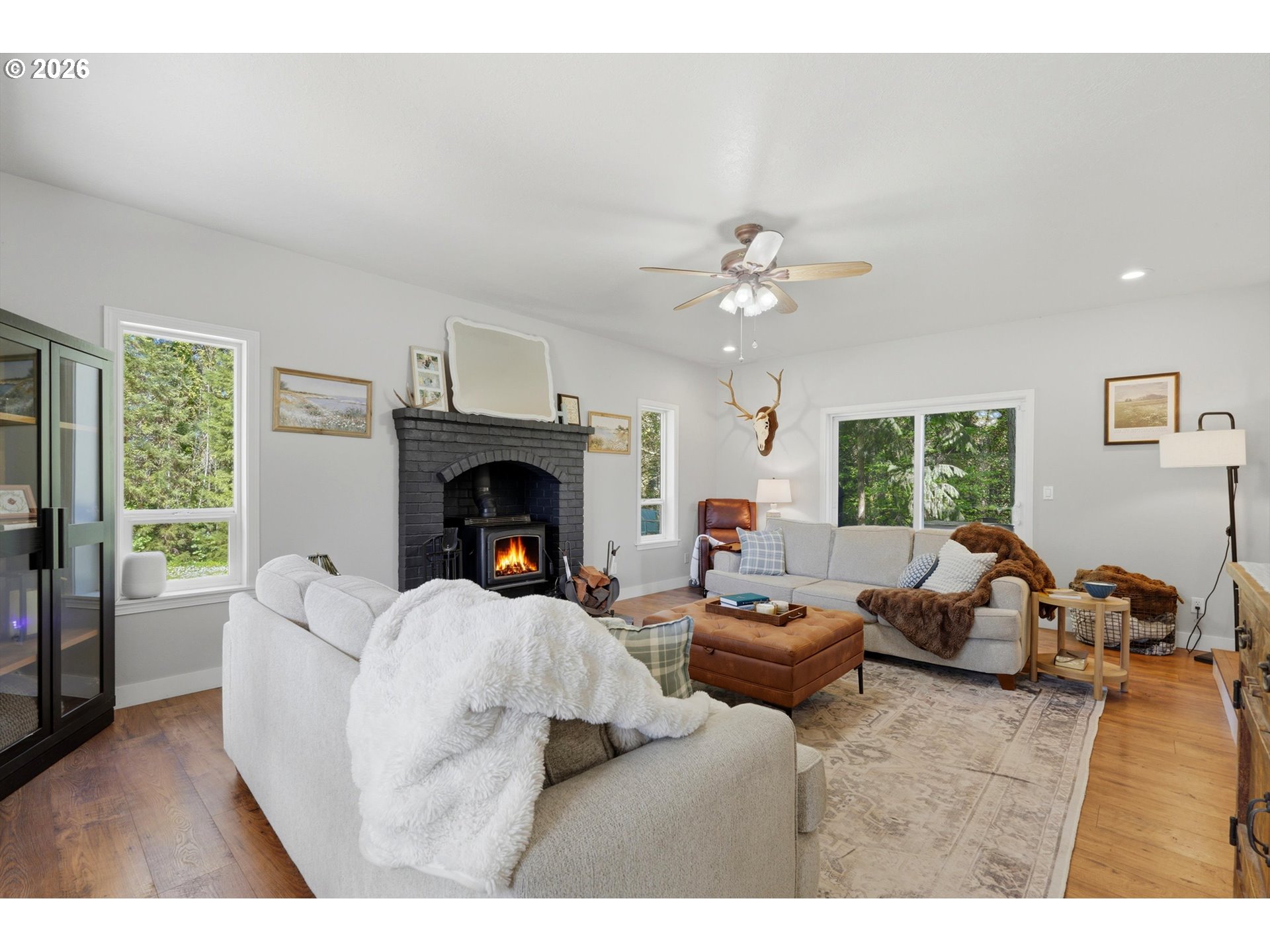 23032 Northeast Hagey Road Dundee, OR 97115 - Photo 5 of 42 a living room with furniture a fireplace and a large window