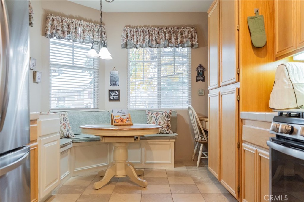 11555 Townsend Way Yucaipa, CA 92399 - Photo 14 of 47 a dining room with kitchen island granite countertop furniture and a fireplace