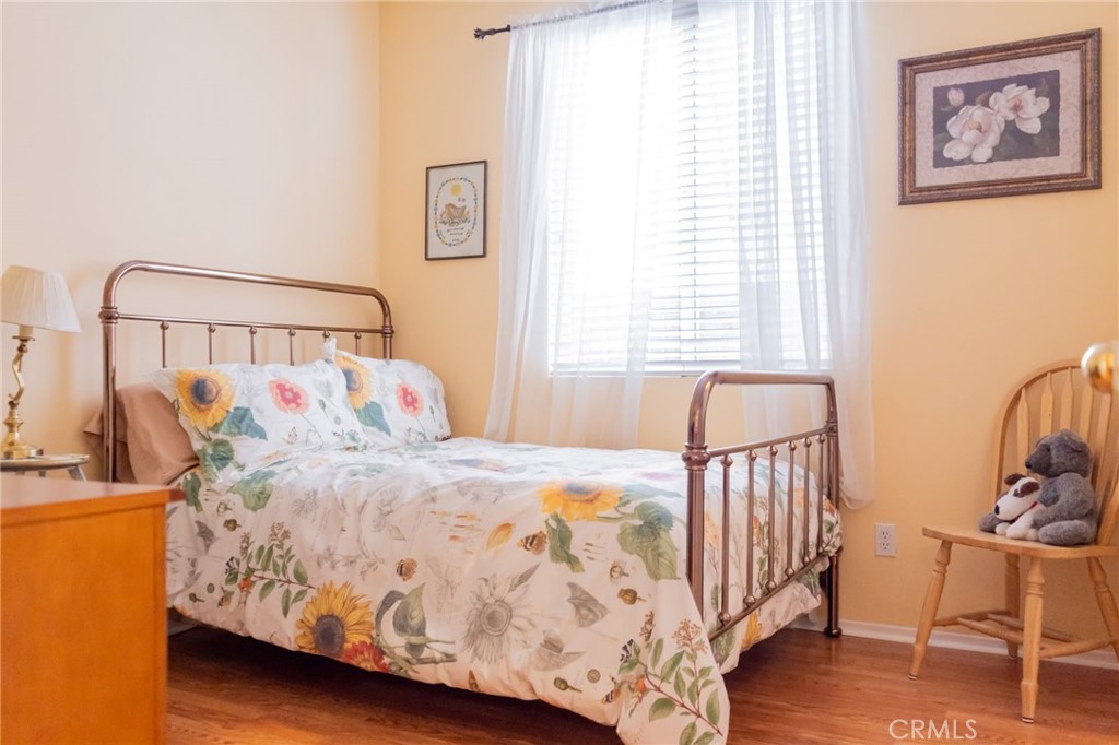 11555 Townsend Way Yucaipa, CA 92399 - Photo 34 of 47 a bed sitting in a bedroom next to a window with a baby crib