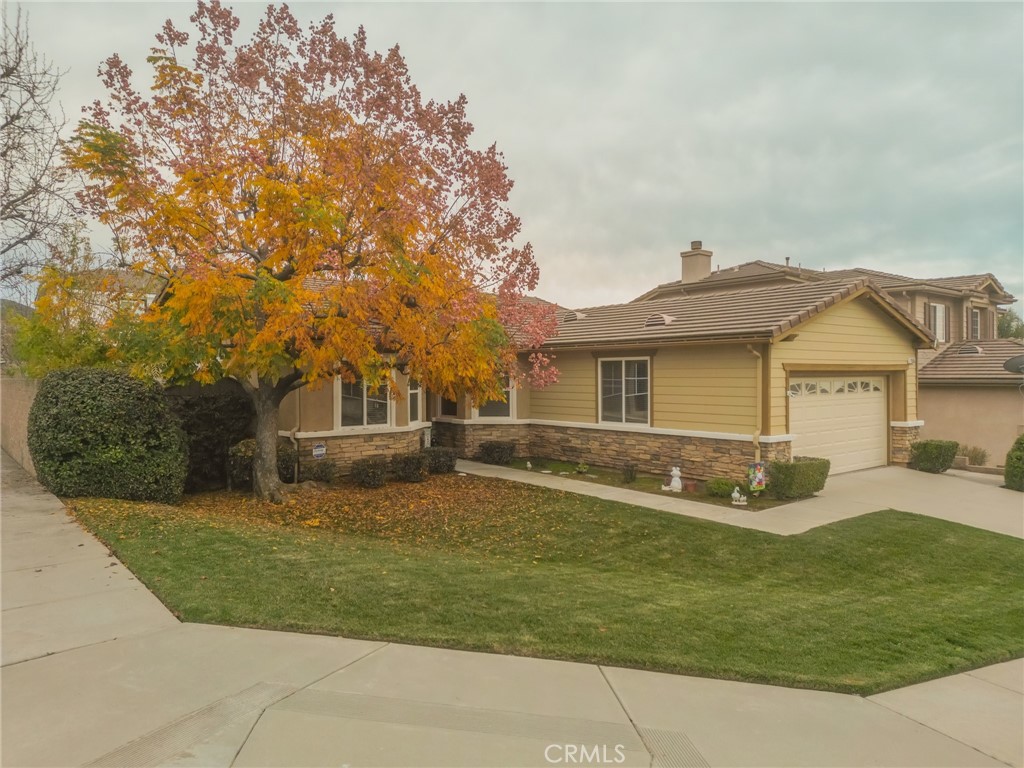 11555 Townsend Way Yucaipa, CA 92399 - Photo 43 of 47 a front view of a house with a garden