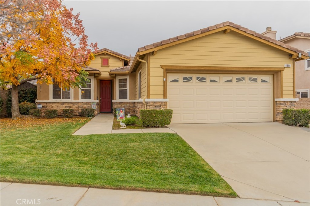 11555 Townsend Way Yucaipa, CA 92399 - Photo 5 of 47 a view of a white house with a yard and plants