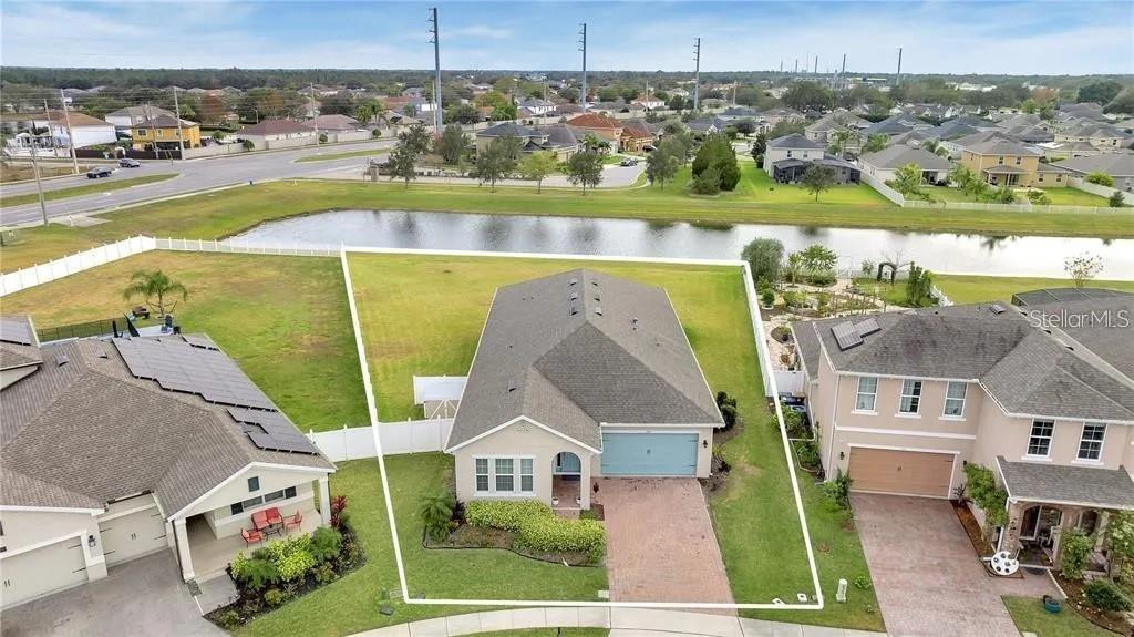 an aerial view of a house with a yard basket ball court and outdoor seating