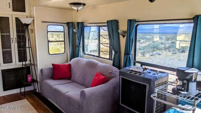 a living room with furniture and a floor to ceiling window