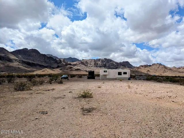 a view of a road with wooden fence