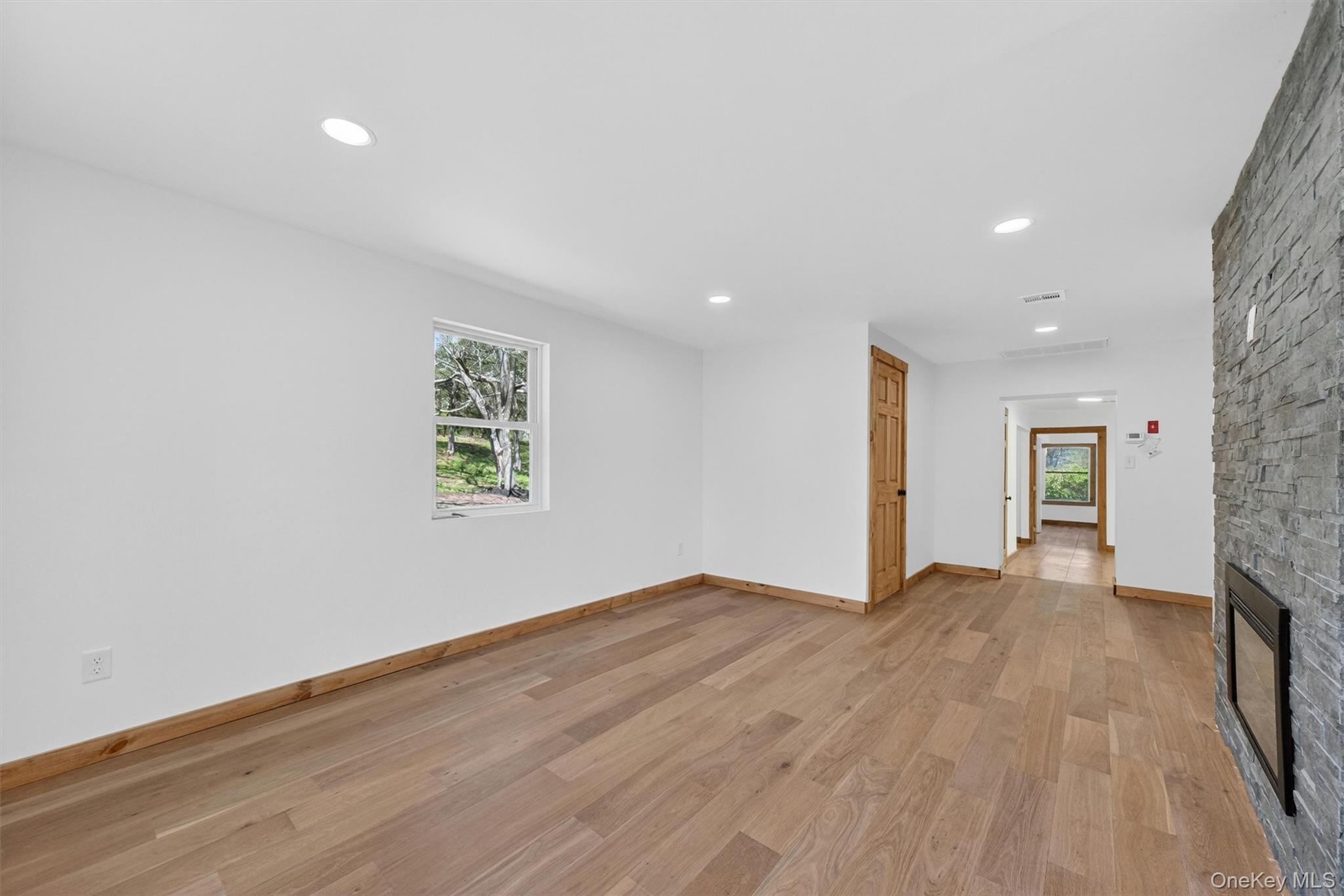 71 Blacks Road Kingston, NY 12401 - Photo 6 of 20 a view of an empty room with wooden floor and a window