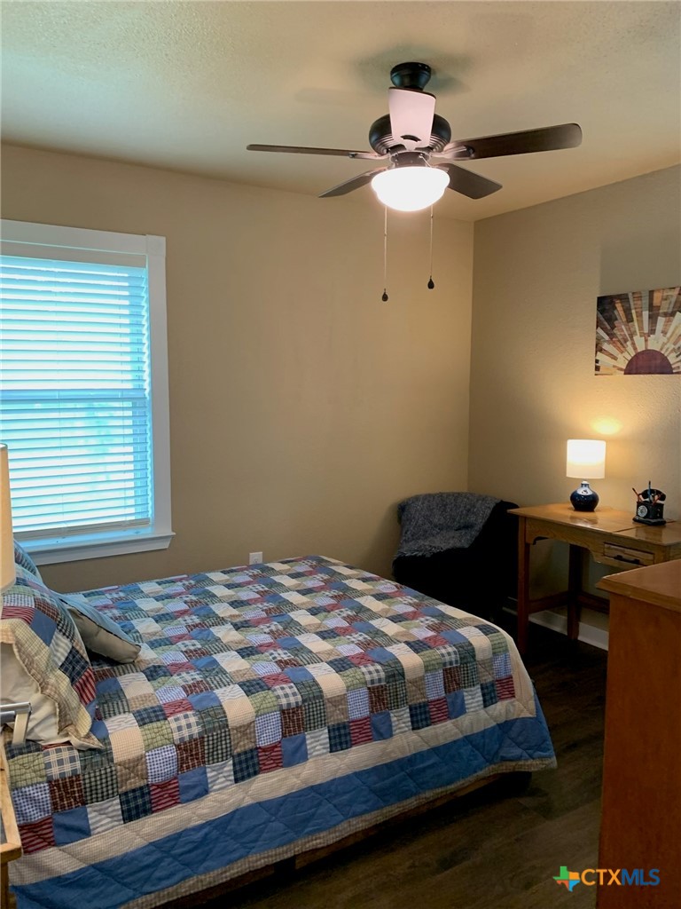 952 Fannin Loop Temple, TX 76501 - Photo 13 of 17 a bedroom with a bed and a chandelier