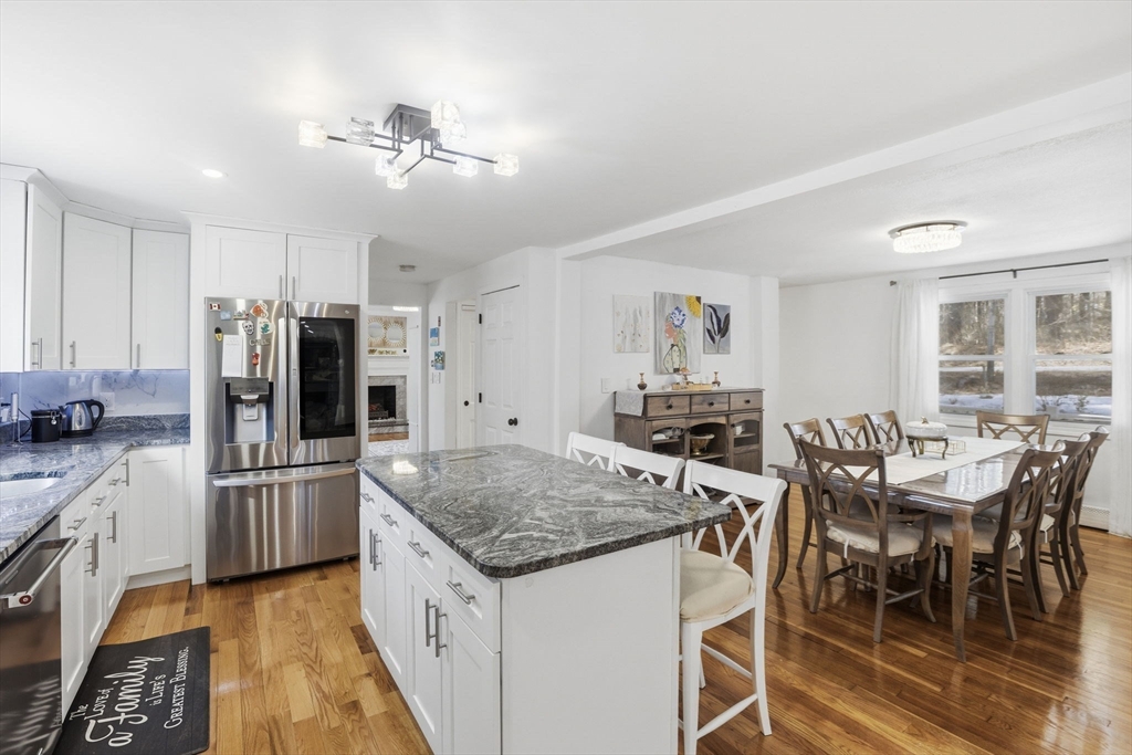 97 Chicopee Row Groton, MA 01450 - Photo 11 of 41 a kitchen with a table and chairs in it