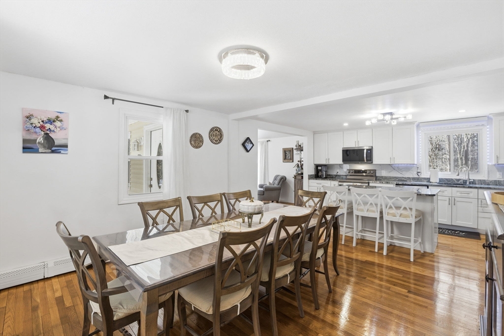 97 Chicopee Row Groton, MA 01450 - Photo 13 of 41 a view of a dining room with furniture and wooden floor