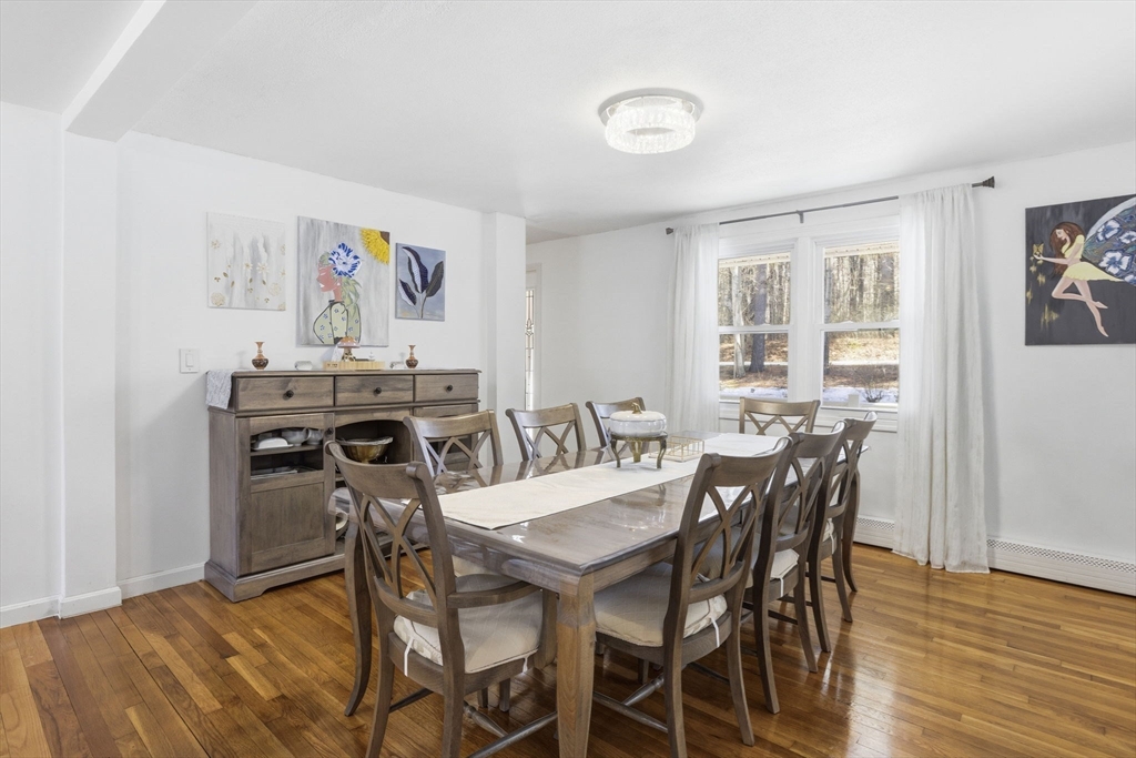97 Chicopee Row Groton, MA 01450 - Photo 15 of 41 a view of a dining room with furniture and wooden floor
