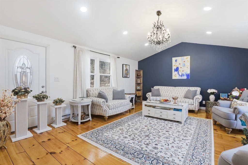97 Chicopee Row Groton, MA 01450 - Photo 16 of 41 a living room with furniture and a chandelier