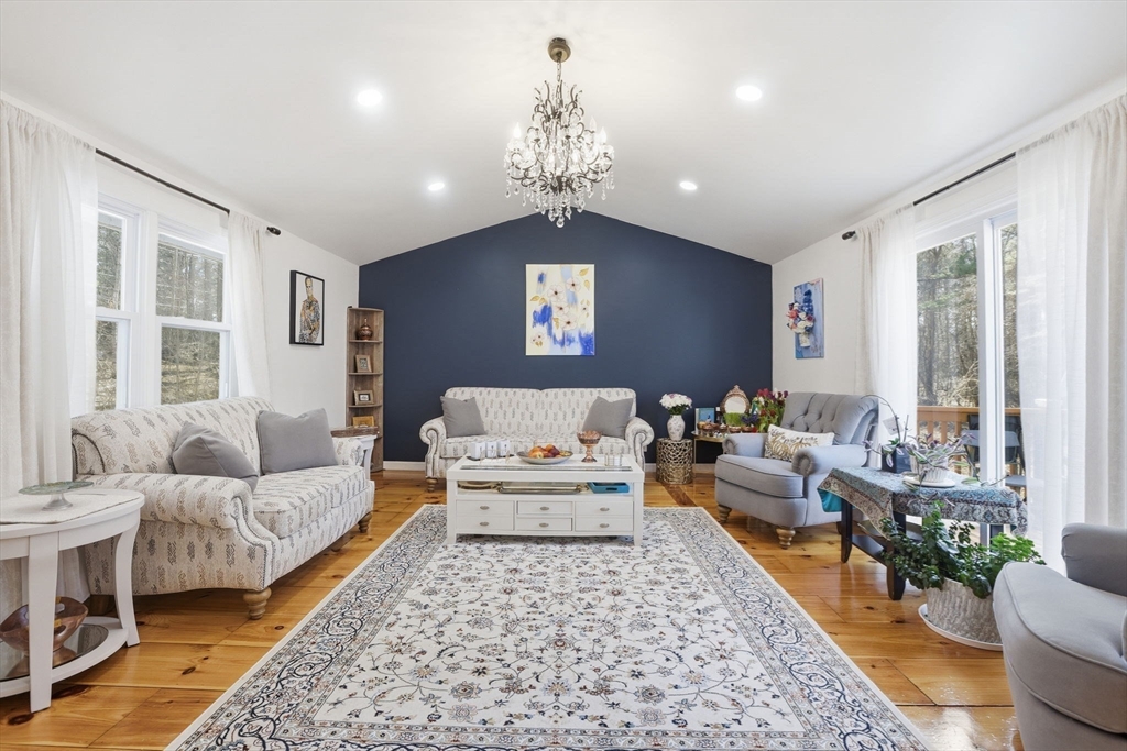 97 Chicopee Row Groton, MA 01450 - Photo 17 of 41 a living room with furniture and a chandelier