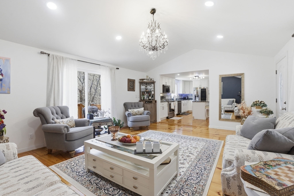 97 Chicopee Row Groton, MA 01450 - Photo 19 of 41 a living room with furniture and a chandelier