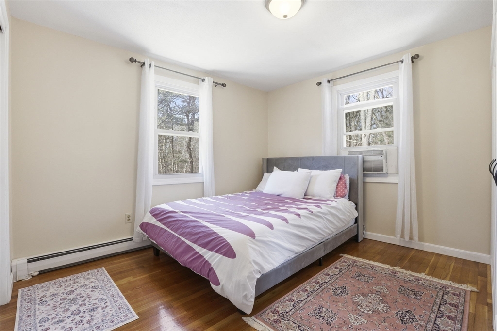 97 Chicopee Row Groton, MA 01450 - Photo 22 of 41 a bed sitting in a bedroom next to a window