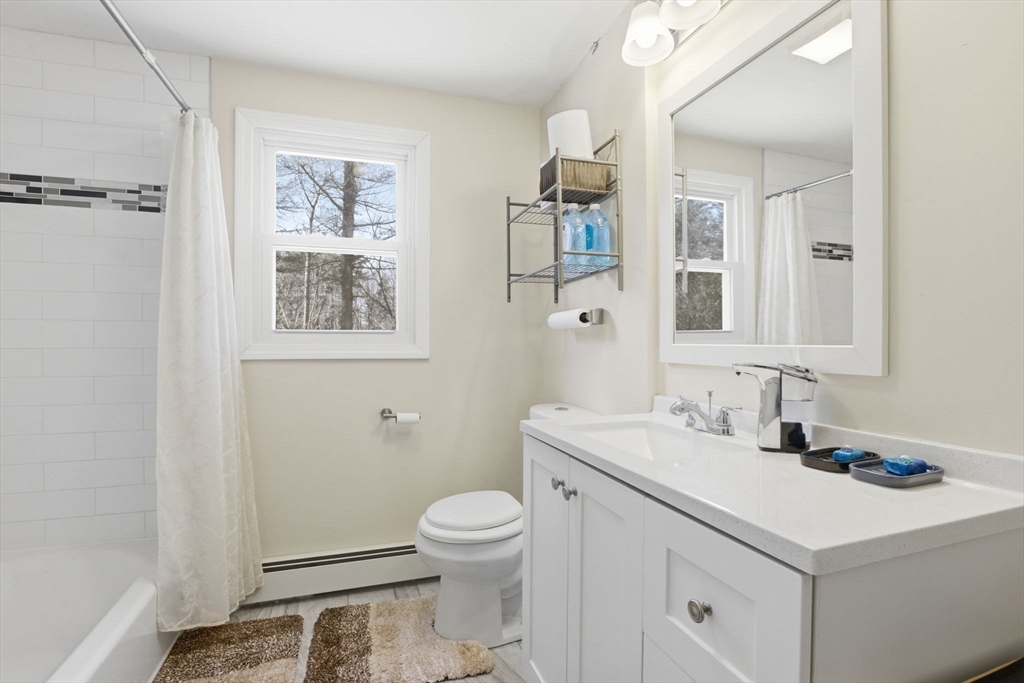 97 Chicopee Row Groton, MA 01450 - Photo 25 of 41 a bathroom with a sink toilet and mirror