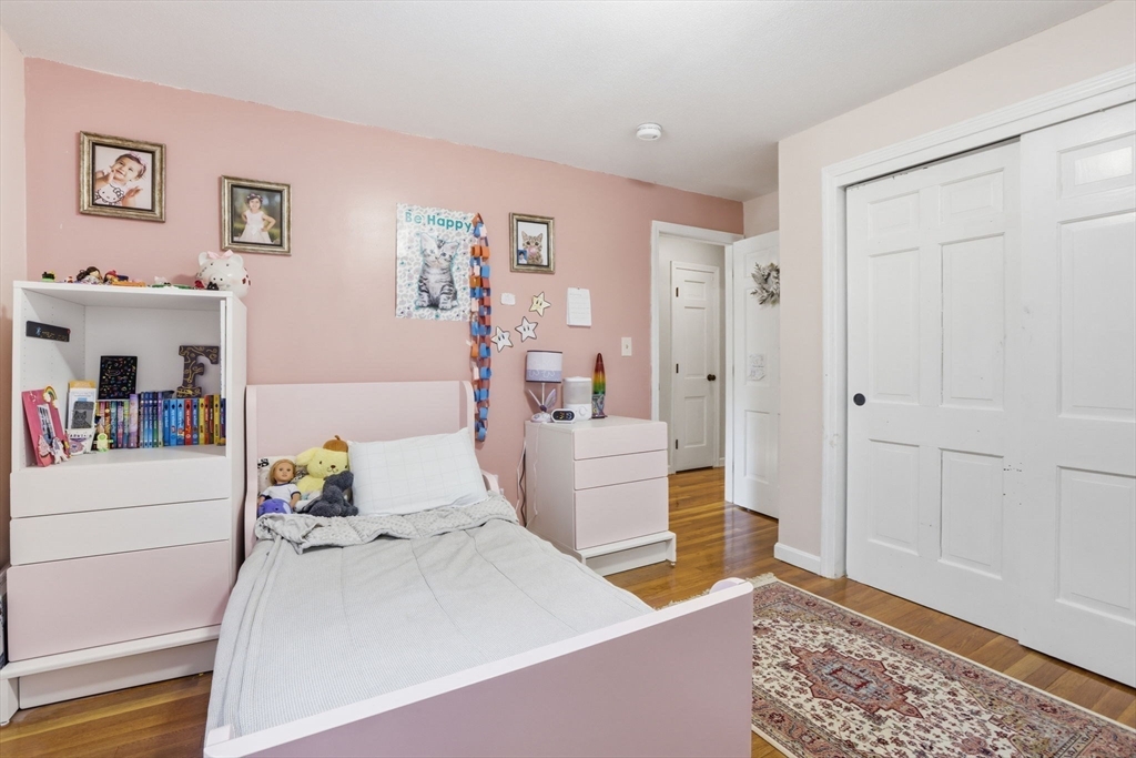 97 Chicopee Row Groton, MA 01450 - Photo 32 of 41 a bedroom with a bed and wooden floor
