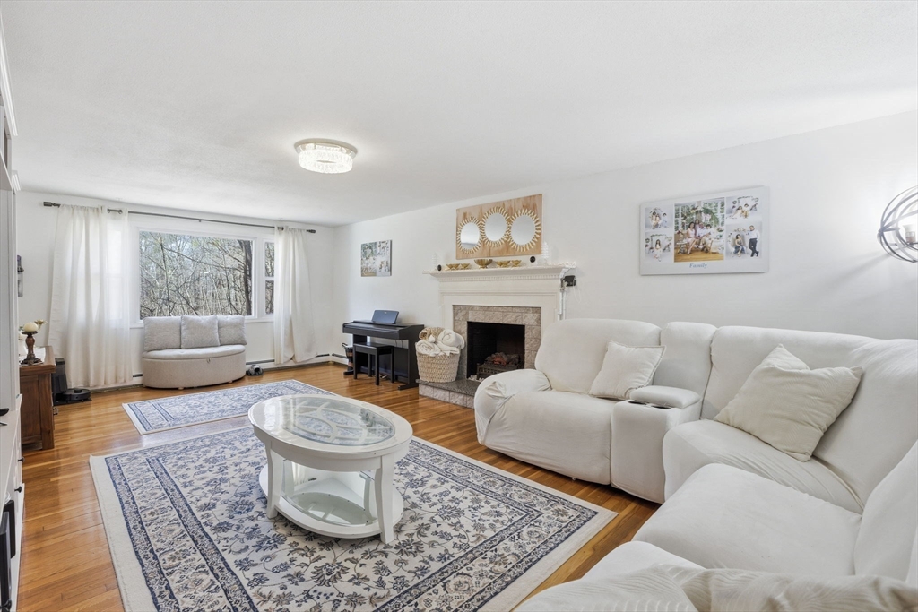 97 Chicopee Row Groton, MA 01450 - Photo 5 of 41 a living room with furniture a rug and a fireplace