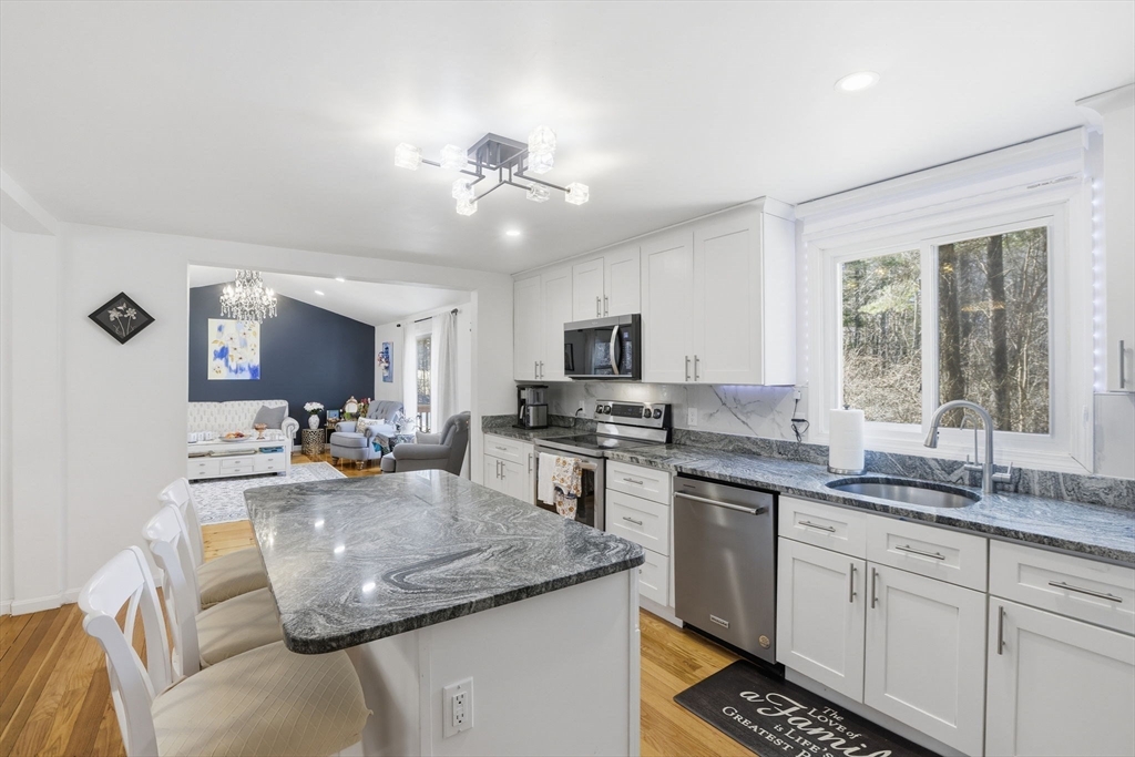 97 Chicopee Row Groton, MA 01450 - Photo 9 of 41 a kitchen with sink stove and cabinets