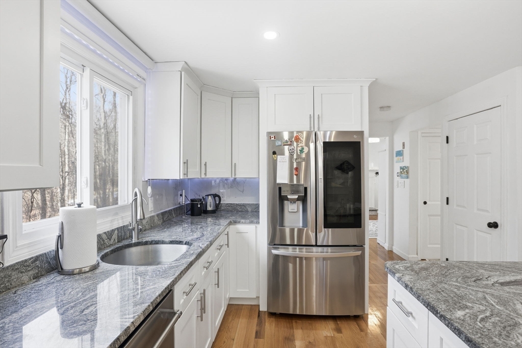 97 Chicopee Row Groton, MA 01450 - Photo 10 of 41 a kitchen with stainless steel appliances granite countertop a refrigerator and a sink