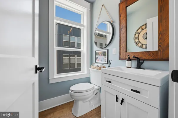 a bathroom with a toilet a sink and a window
