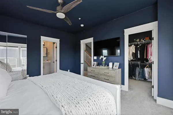 a bedroom with a bed and a large mirror with a flat tv screen