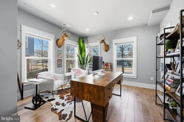 a living room with furniture and wooden floor