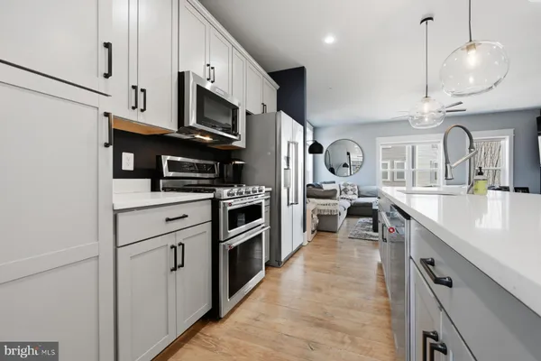 a kitchen with stainless steel appliances granite countertop a stove a sink and a refrigerator