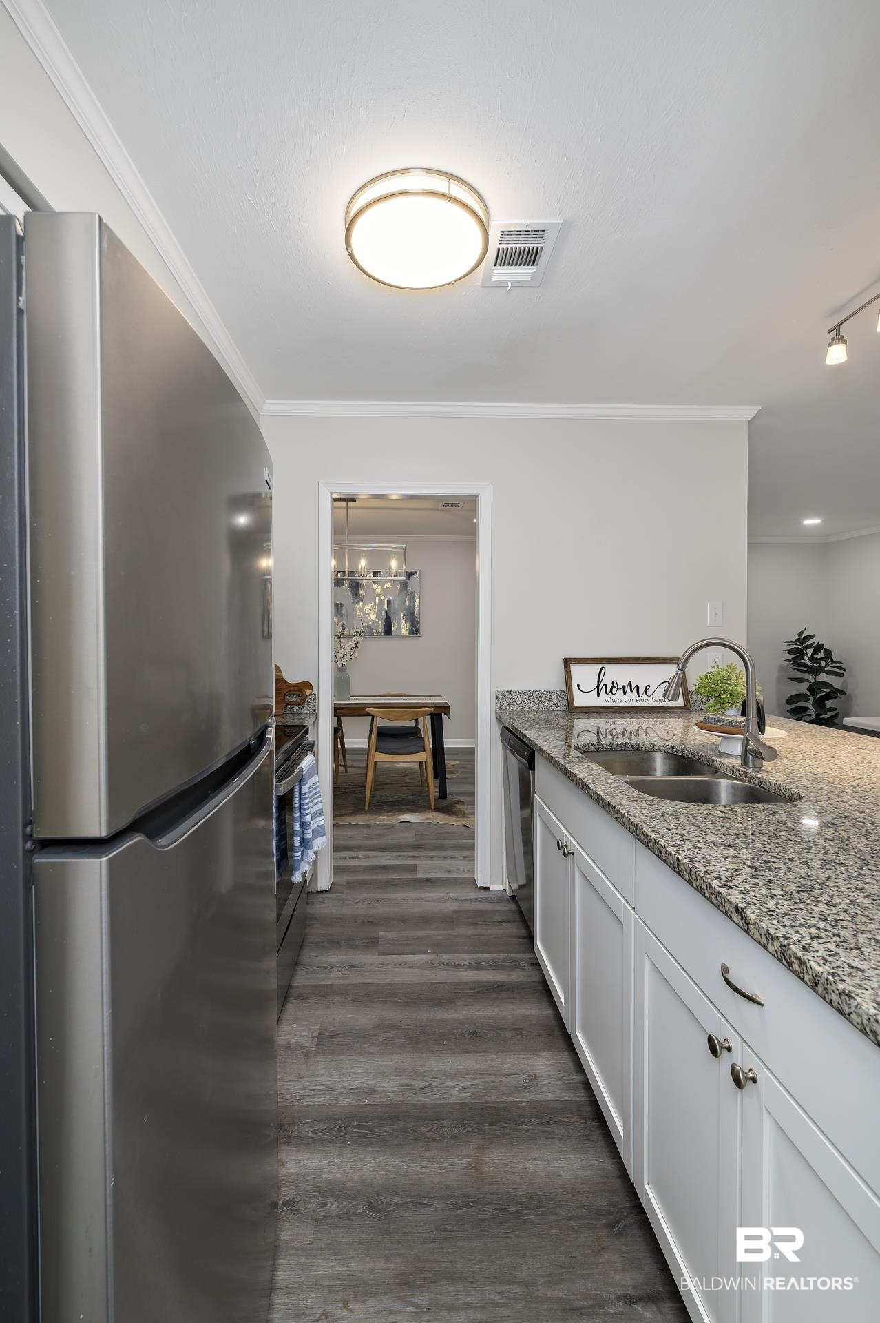 5922 Sunnyside Drive Mobile, AL 36619 - Photo 42 of 51 Kitchen with appliances with stainless steel finishes, a sink, ornamental molding, dark wood finished floors, and light stone countertops