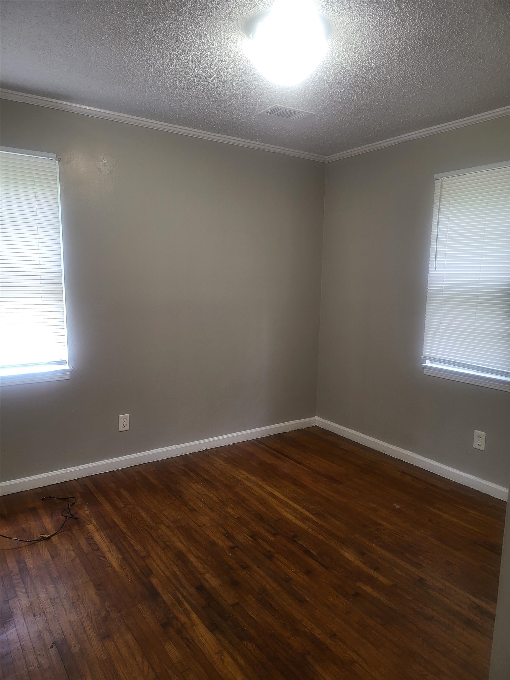 3705 Suzanne Drive Memphis, TN 38127 - Photo 5 of 10 an empty room with wooden floor and windows