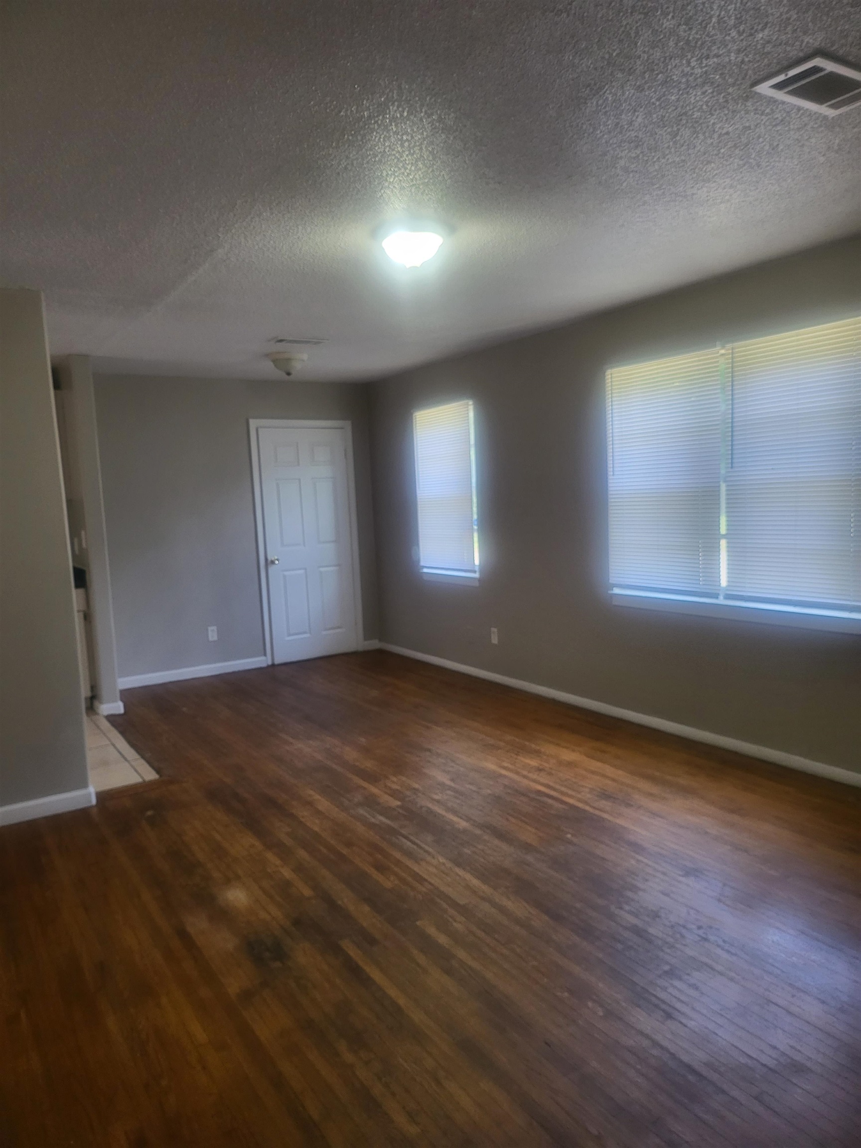 3705 Suzanne Drive Memphis, TN 38127 - Photo 8 of 10 an empty room with wooden floor and windows