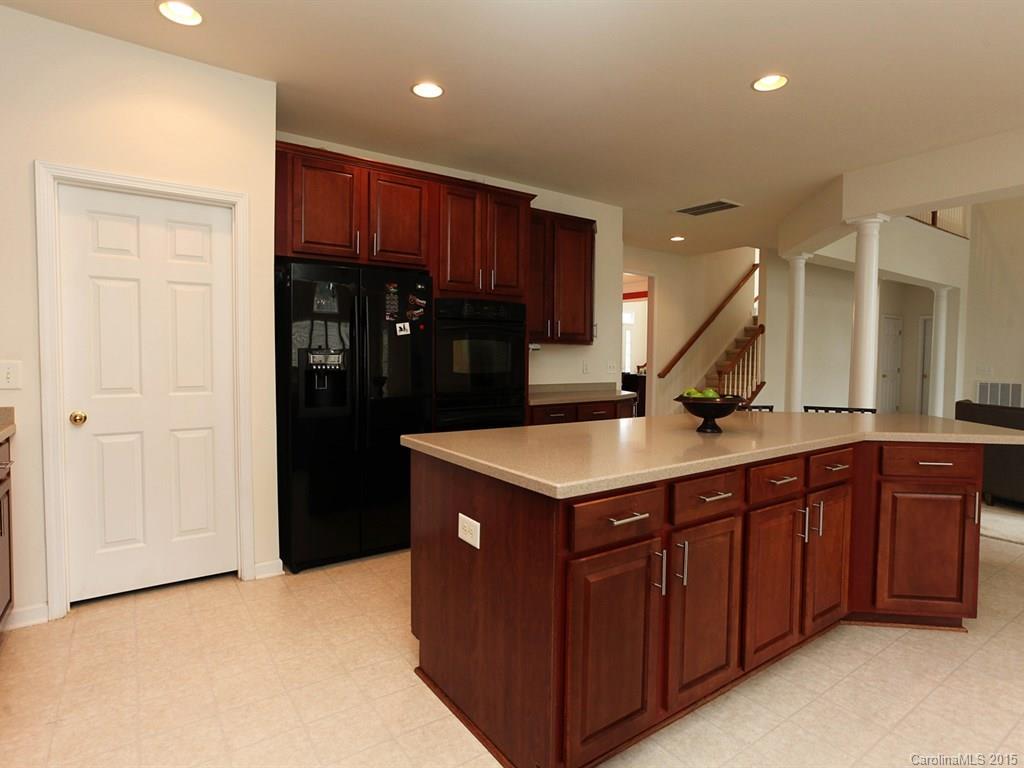 1962 Faison Avenue Fort Mill, SC 29708 - Photo 11 of 24 a kitchen with stainless steel appliances granite countertop a refrigerator a sink and wooden cabinets