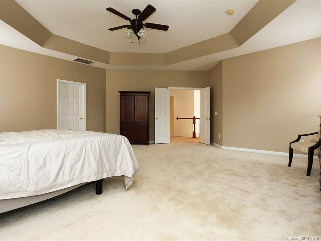 1962 Faison Avenue Fort Mill, SC 29708 - Photo 17 of 24 a spacious bedroom with a bed and a chandelier