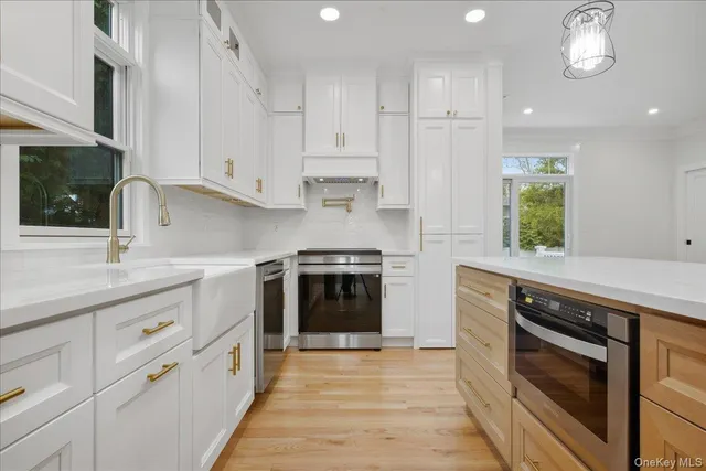 a kitchen with a sink stainless steel appliances and cabinets