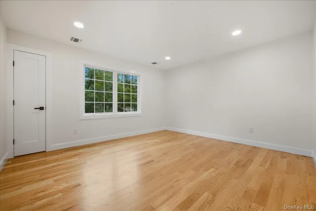 a bathroom with a sink a toilet a mirror and shower