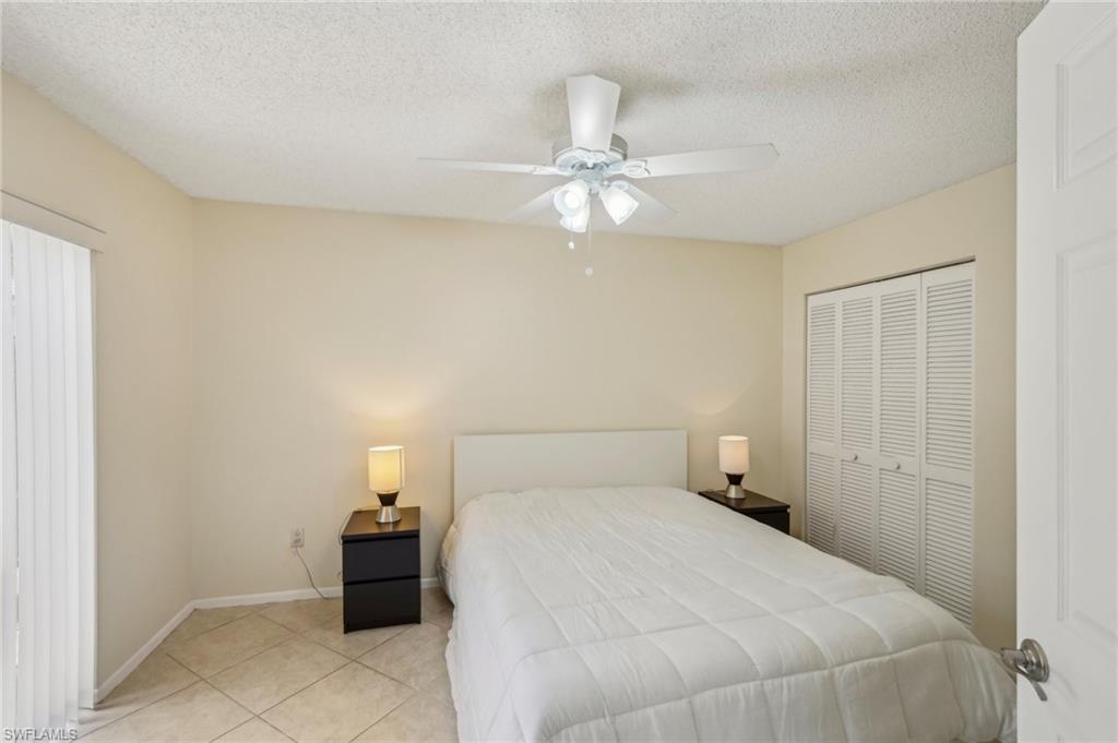 13345 Broadhurst Loop Fort Myers, FL 33919 - Photo 16 of 33 Tiled bedroom with a ceiling fan, a textured ceiling, and a closet