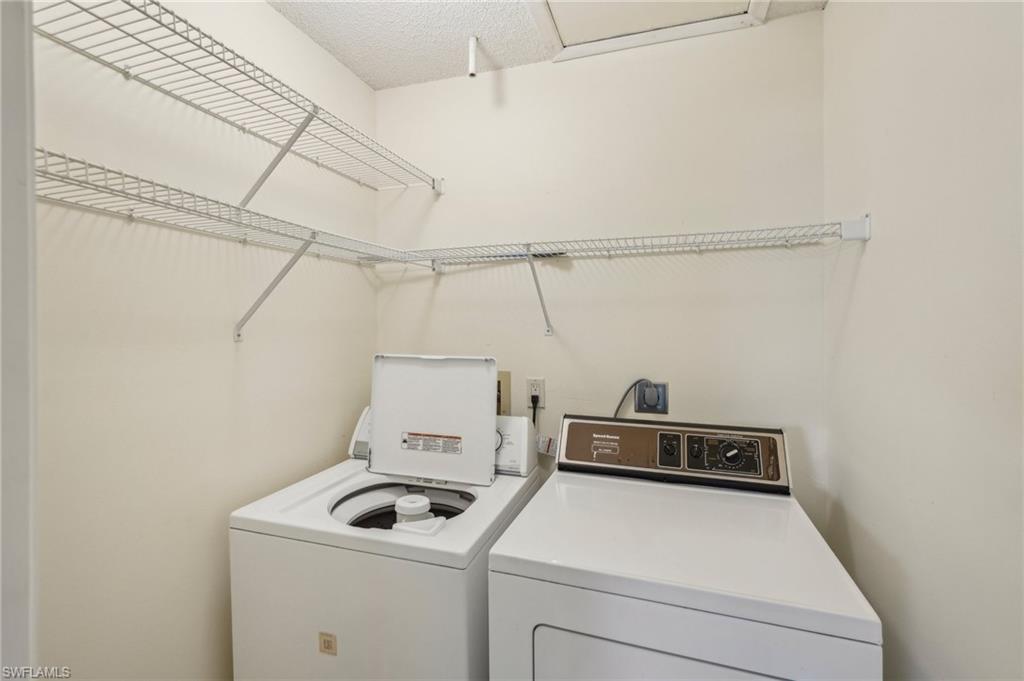 13345 Broadhurst Loop Fort Myers, FL 33919 - Photo 21 of 33 Washroom with washer and dryer and a textured ceiling