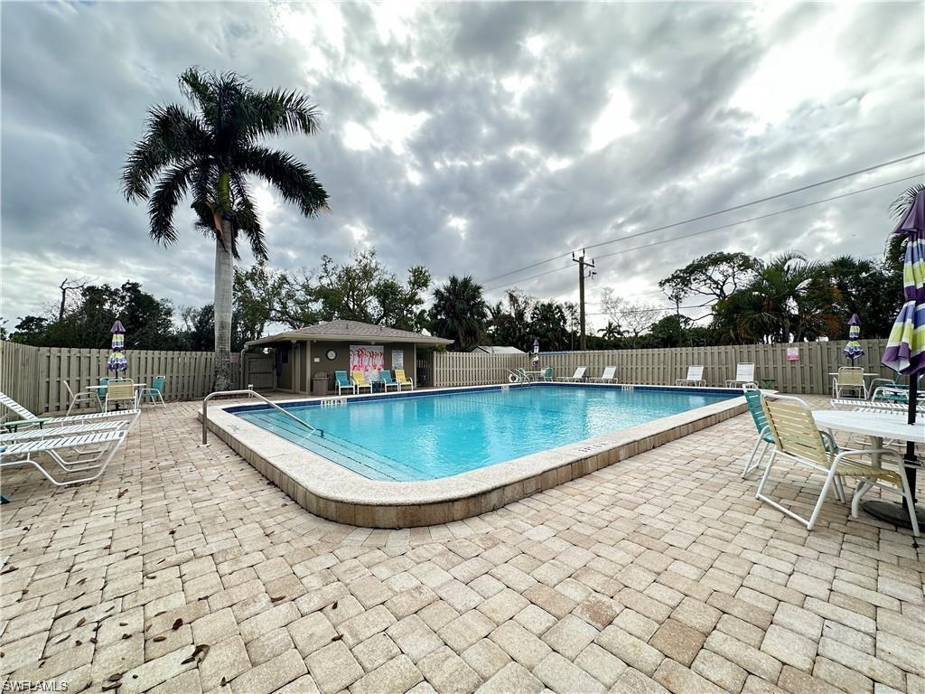 13345 Broadhurst Loop Fort Myers, FL 33919 - Photo 6 of 33 Community pool featuring a patio and outdoor dining area