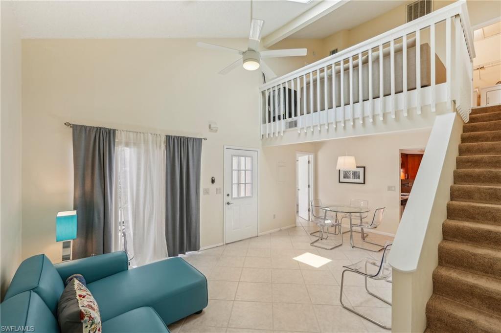 13345 Broadhurst Loop Fort Myers, FL 33919 - Photo 10 of 33 Living room featuring stairs, a high ceiling, ceiling fan, and tile patterned flooring