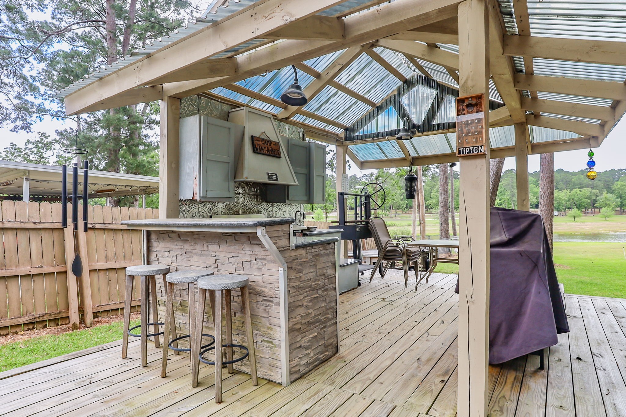 628 County Road 452 Bronson, TX 75930 - Photo 15 of 50 a view of a patio with table and chairs wooden floor and a floor to ceiling window