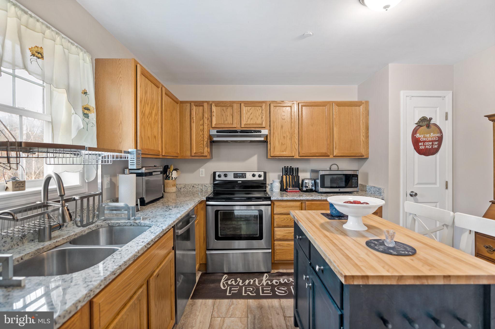 5632 Hines Road Frederick, MD 21704 - Photo 17 of 44 a kitchen with granite countertop a sink stove and cabinets
