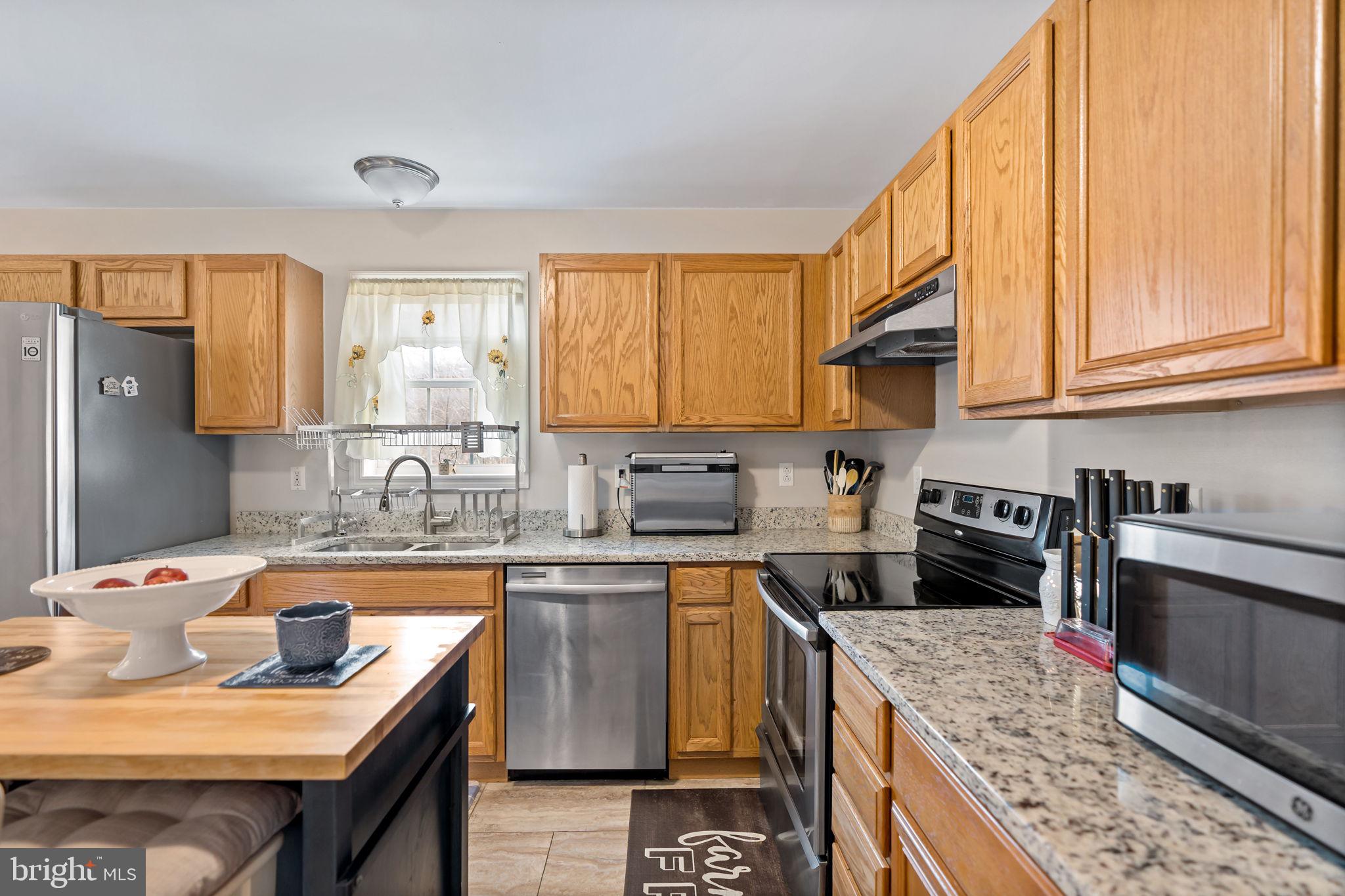 5632 Hines Road Frederick, MD 21704 - Photo 18 of 44 a kitchen with stainless steel appliances granite countertop a sink stove and refrigerator