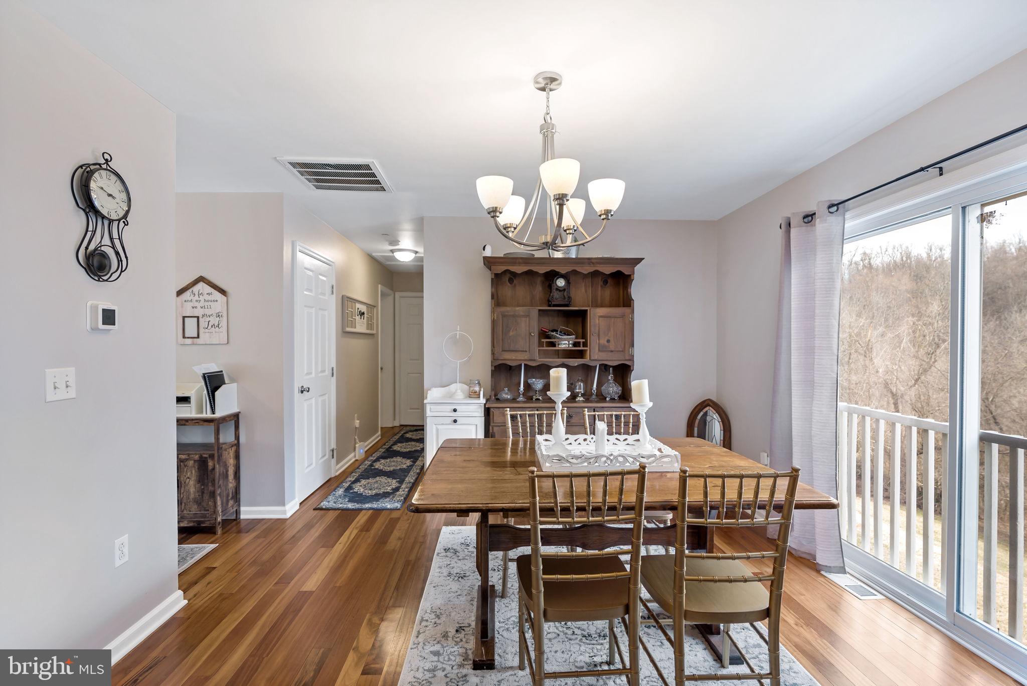 5632 Hines Road Frederick, MD 21704 - Photo 19 of 44 a view of a dining room with furniture wooden floor and chandelier