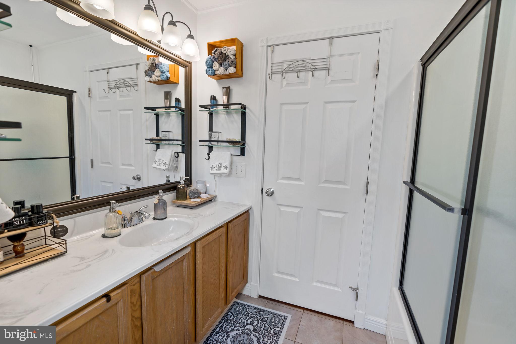 5632 Hines Road Frederick, MD 21704 - Photo 28 of 44 a bathroom with a sink a mirror and shower