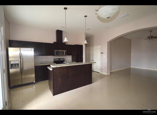 2705 Mimosa Street, Unit 4 Mission, TX 78574 - Photo 7 of 24 a kitchen with stainless steel appliances granite countertop a refrigerator a sink and a stove