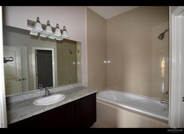 2705 Mimosa Street, Unit 4 Mission, TX 78574 - Photo 10 of 24 a bathroom with a sink a toilet and shower