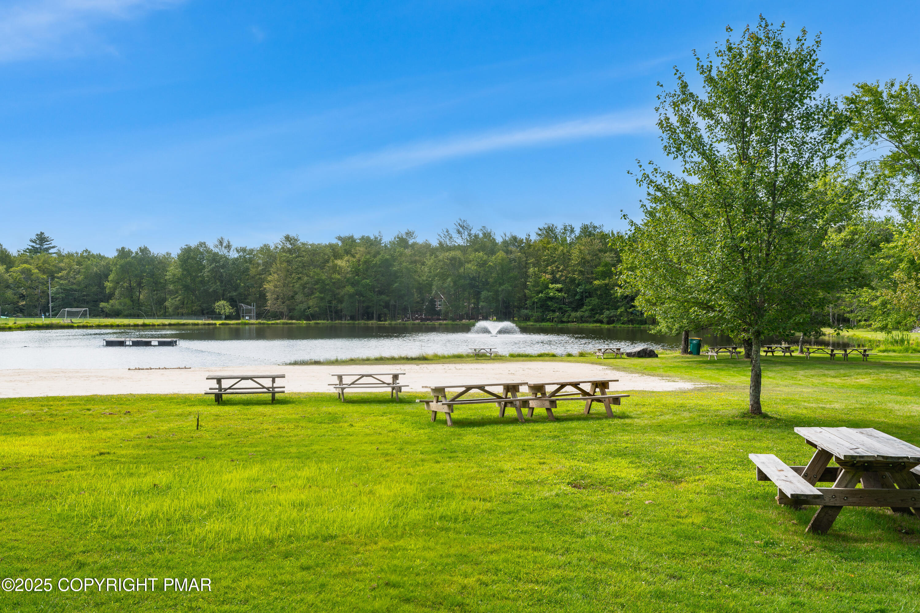 804 Evergreen Road Pocono Lake, PA 18347 - Photo 10 of 19 a view of a swimming pool with a garden and trees