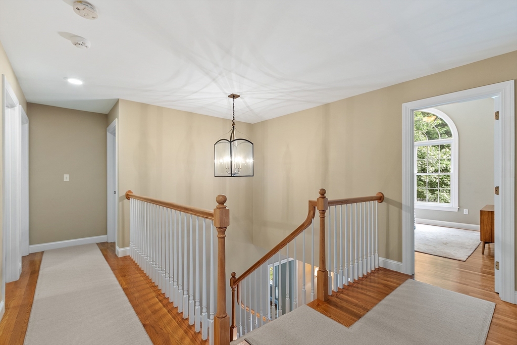 3 Coderre Way Andover, MA 01810 - Photo 23 of 42 a view of staircase with wooden floor and chandelier