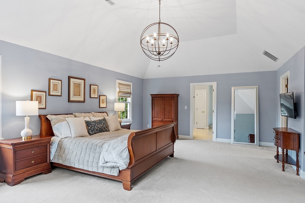 3 Coderre Way Andover, MA 01810 - Photo 27 of 42 a spacious bedroom with a bed and a chandelier